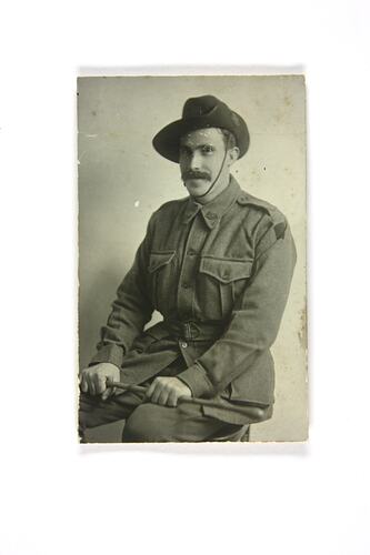 Photographic portrait of seated soldier.