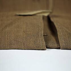 Partially folded paillasse with opening detail.