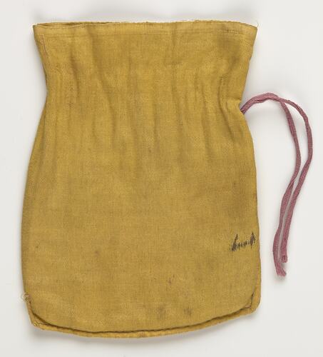 Yellow cloth bag with a pink drawstring.