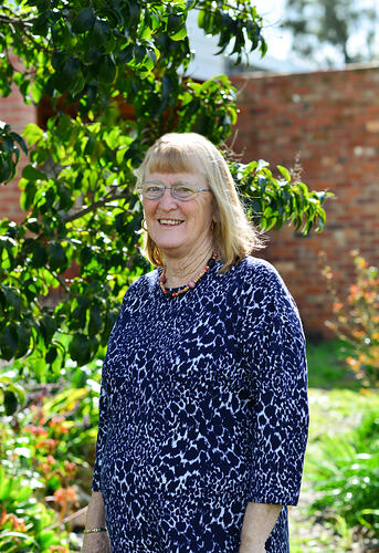 Woman beside a tree.