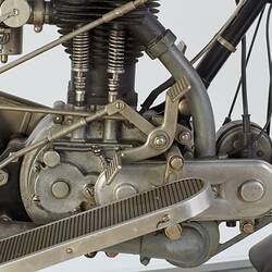 Motor cycle, foot rest, accelerator and engine detail. Right view.