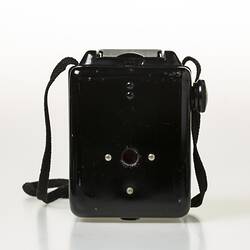 Box camera with black plastic body, black shoulder strap. Back view.