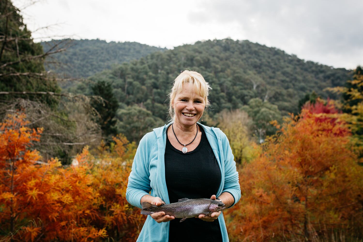 Digital Photograph Trout farmer Sally Hall Holding a Trout on her