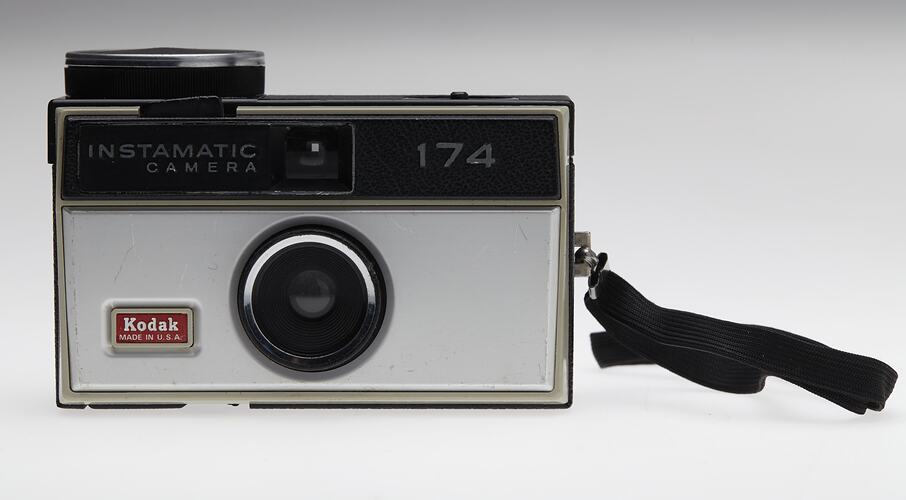 Black and grey plastic camera with black strap.