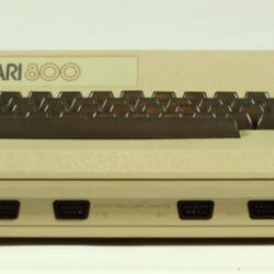 Front view of beige plastic unit with keyboard.