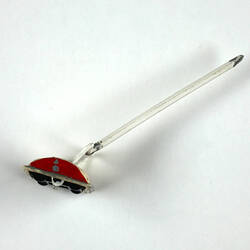 Plastic toy carpet sweeper, side view.