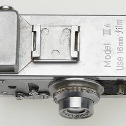 Bottom of a miniature metal camera.