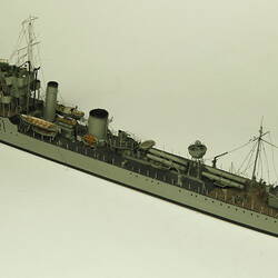Grey coloured naval ship, three quarter view.