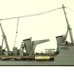 Naval ship with two masts, facing right.