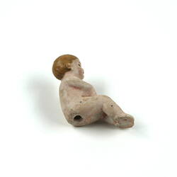 Tiny toy baby, underside.
