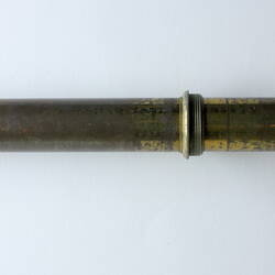 Long narrow brass scientific instrument.