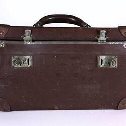 Brown suitcase with lid closed.