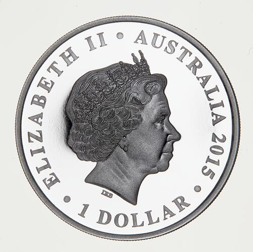 Round silver coin with crowned Queen's head facing right.