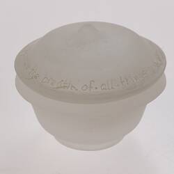 Opaque glass round spice container with lid. Narrower at base.