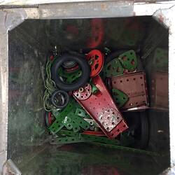 Inside tin box containing construction pieces.