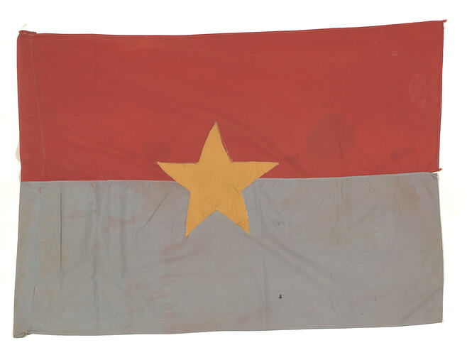 Rectangular banner with horizontal red stripe over grey stripe. Yellow star in centre.