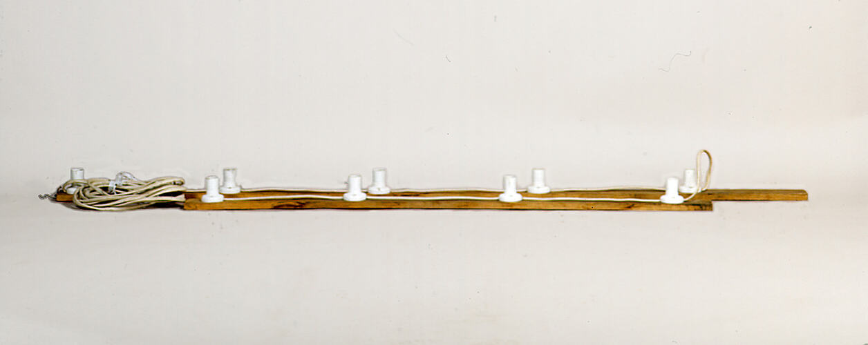 Wooden frames with white light sockets and cord.