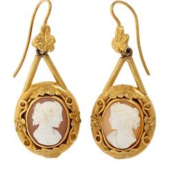 Gold mounted cameo earrings. Round white cameo profile bust with brown background, gold border.