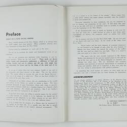 Open booklet with white pages and black printing.