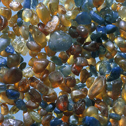 Blue red and brown uncut sapphires.