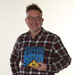 Man wearing chequer pattern shirt holding blue surise logo with yellow smiling sun.