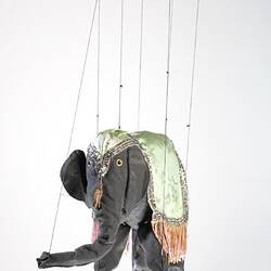 Grey elephant marionette with grey silk coat. Wooden handle, strings attached.
