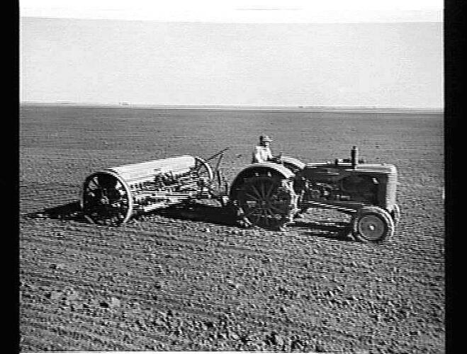 SOWING IN THE WIMMERA MUD. MR.J. LUDLOW, DOOEN, VIC., SOWS 800 ACRES WITH HIS NEW 500-SERIES `SUNTYNE' CULTIVATING DRILL AND 55K SUNSHINE MASSEY HARRIS TRACTOR: JUNE 1952
