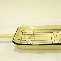 Rectangular yellow enamel grill pan with handle. Removable wire rack sits inside pan.