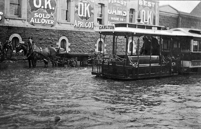 [A cable tram negotiating floodwaters in Chapel Street, South Yarra, 1907.]