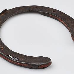 Handmade 'U' shaped metal horseshoe, with red rubber inserts.