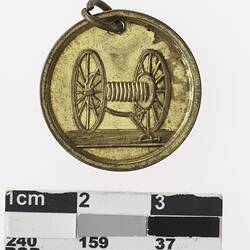 Round medal with fire hose reel.