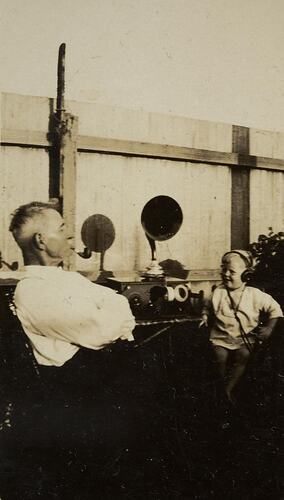 Digital Photograph - Man & Boy Listening to Crystal Set Radio, Backyard, Yarraville, circa 1925
