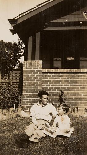 Digital Photograph - Man & Boy with Book, Front Garden, Ivanhoe, circa 1943