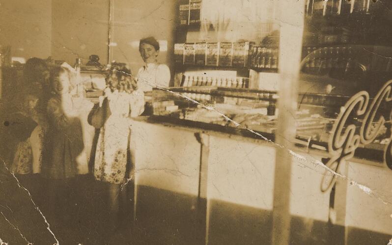Digital Photograph - Shopkeeper Serving Behind Counter at Family Milk Bar, Moonee Ponds, 1949