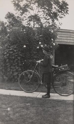 Digital Photograph - Girl in School Uniform and Hat, Standing with Bicycle near Shed, Backyard, Colac, 1940