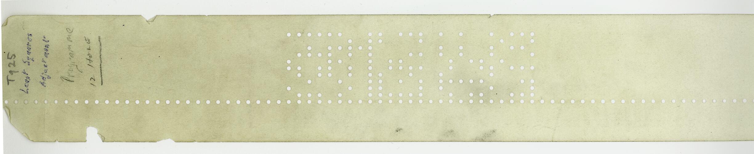 Rectangular paper card with text and punched holes.