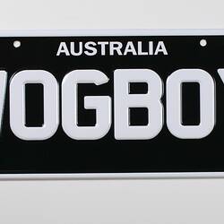 Number plate, black with white writing.