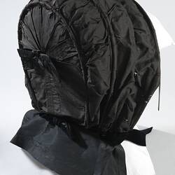 Black bonnet with ties around the chin.