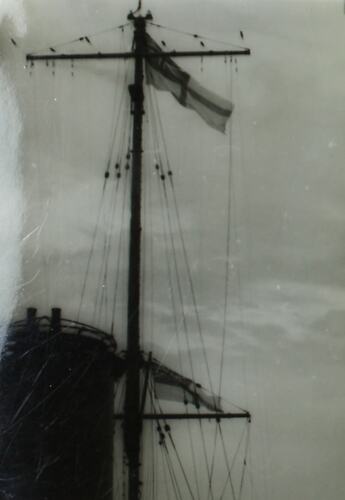 Ships funnel and mast with flag.
