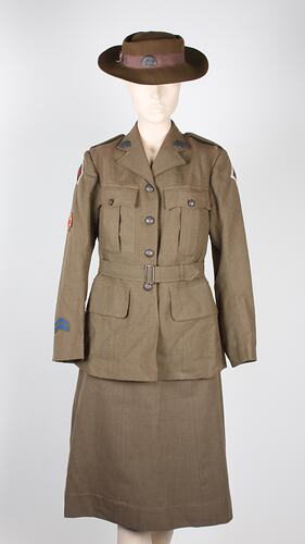 Female army uniform, skirt, belted jacket, and hat.