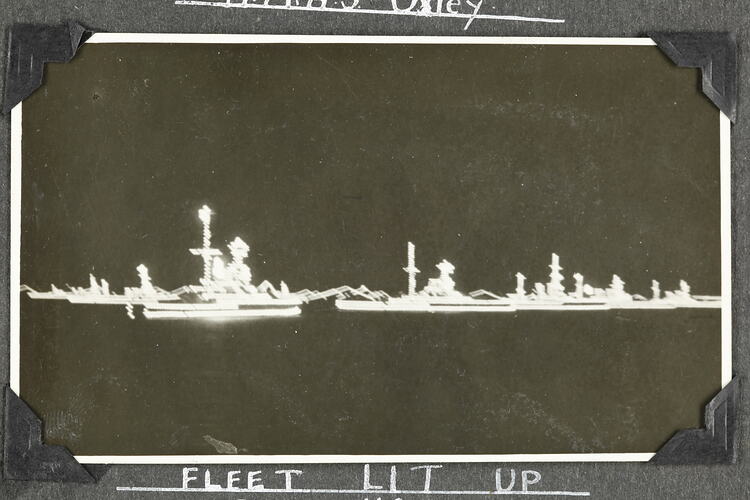 Side view of military ship at night.