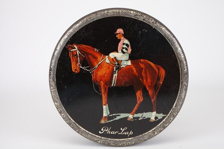 Cake tin with picture of race horse.