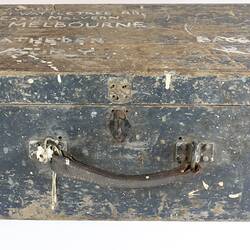 Wooden trunk with metal clasps and leather handle.