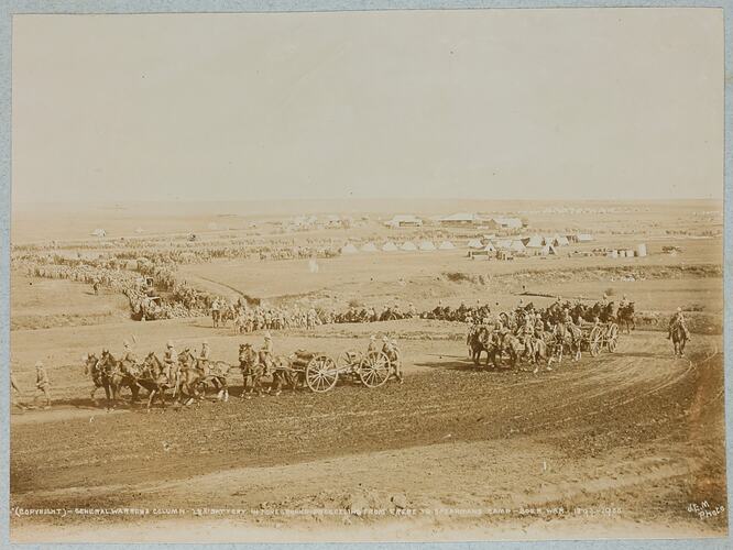 Camp with tents in background and groups of soldiers on horseback riding in formation away from camp.
