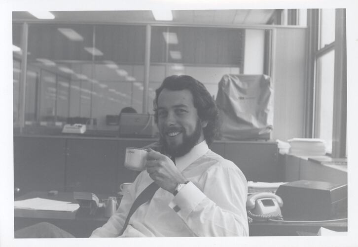 Photograph - Kodak Australasia Pty Ltd, Man at Desk with Coffee Cup, Building 8, Coburg, 1969-1970