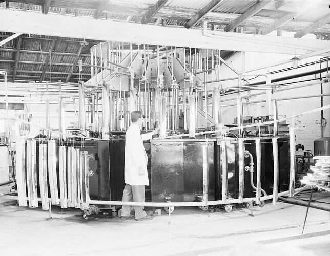 Monochrome photograph of a factory worker.