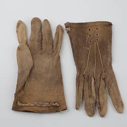 Pair of mid-brown cotton gloves, one upside down