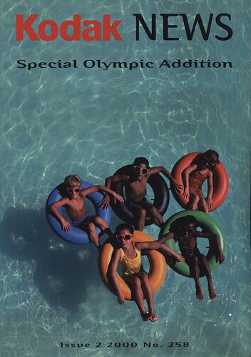 Magazine cover featuring children in swimming pool.