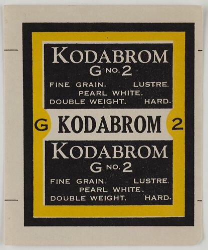 Unused rectangular packaging label. Yellow, black and white background with black and white text.