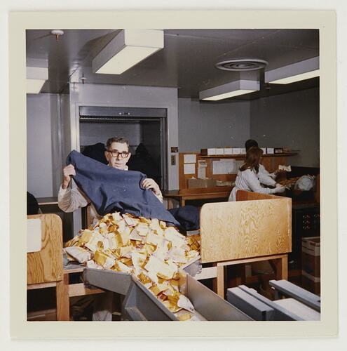 Slide 223, 'Extra Prints of Coburg Lecture', Worker Emptying Mail Bag of Films for Processing, Building 20, Kodak Factory, Coburg, circa 1960s
